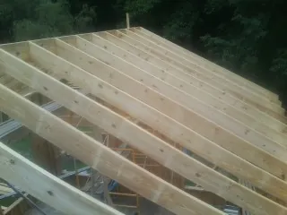 New roof rafters set over an addition before sheathing in Abingdon