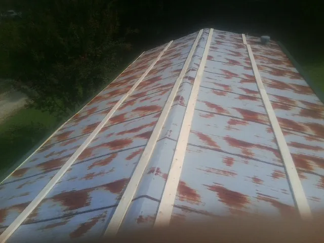 Rusted metal roof panels with new wood purlins before replacement — Storm Damage Roof Repair in Abingdon by Roofing Brothers